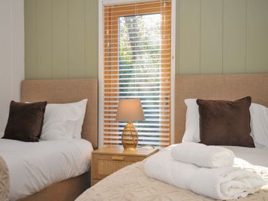 A bedroom with two beds and a window at 6 Stonerush Valley Looe