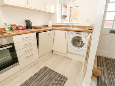 A kitchen with appliances at Harbour View Poole