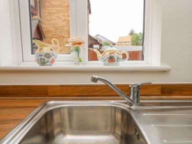 A sink and decorative items on a window sill at Harbour View Poole