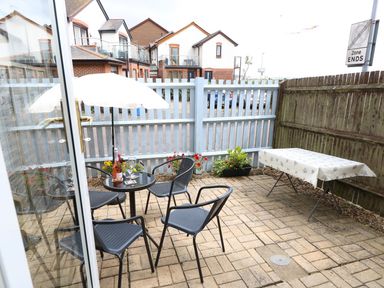 An outdoor area with a table and chairs at Harbour View Poole