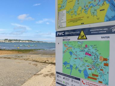 A map and sign near the water showing a personal watercraft area at Harbour View Poole