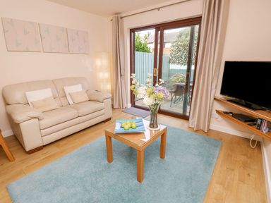 A living room with a sofa and a coffee table at Poole Quay Cottage in Poole