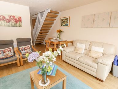 A living room with sofas and a dining table at Poole Quay Cottage in Poole