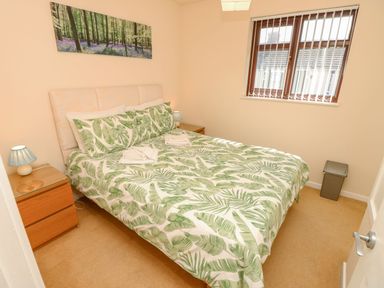 A bedroom with a bed and bedside tables at Poole Quay Cottage in Poole
