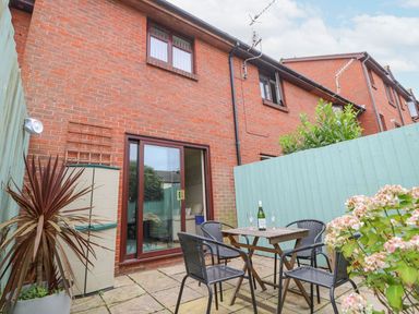A garden with table and chairs at Poole Quay Cottage in Poole