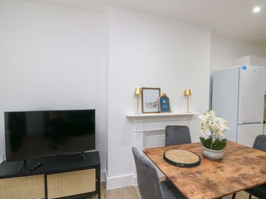 A dining room with a table and chairs at Beachwalk Villa 2 in Whitby