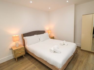 A bedroom with a bed and lamps at Beachwalk Villa 2, Whitby