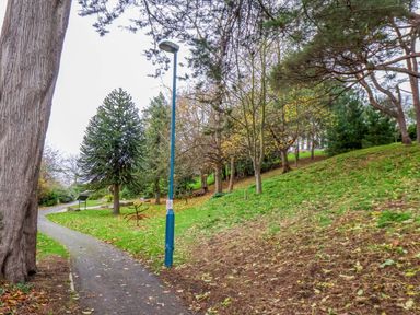 A park pathway with trees and a lamp post at Beachwalk Villa 3, Whitby