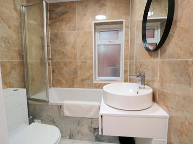 A bathroom with a sink and shower at Beachwalk Villa 3 in Whitby