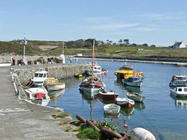 A harbor with several boats at Tyddyn Gyrfa Cottage in Cemaes Bay