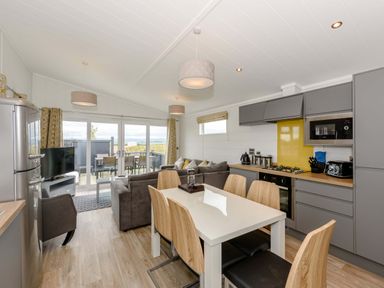 A kitchen with dining area and lounge space at Blencathra Family in Penrith