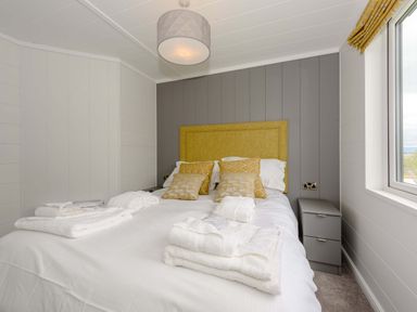 A bedroom with a bed and bedside table at Blencathra Family in Penrith