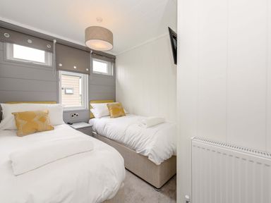 A bedroom with two beds and a television at Blencathra Family in Penrith