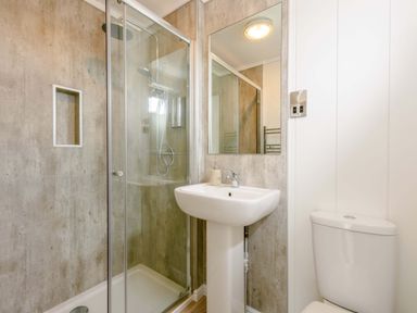 A bathroom featuring a shower, sink, and toilet at Blencathra Family in Penrith