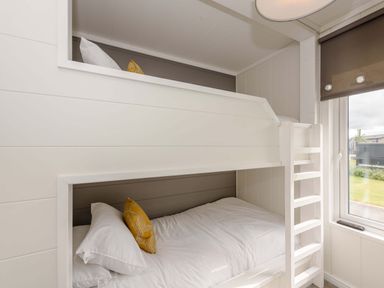 A bedroom with a bunk bed and window at Blencathra Family Penrith