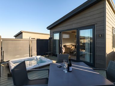 An outdoor area with a hot tub and dining table at Grasmere in Penrith