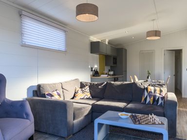 A living room with a sofa and chess set at Grasmere in Penrith