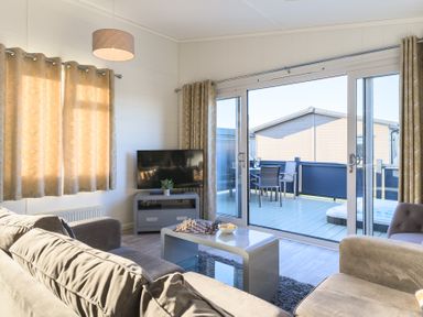 A living room with a television and a sliding door at Grasmere in Penrith