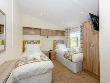 A bedroom with twin beds and a wardrobe at Keswick in Penrith