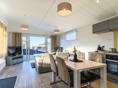 A living room with a dining table and sofa at Grasmere (Pet) Penrith
