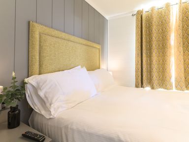A bedroom with a bed and bedside table at Grasmere (Pet) Penrith