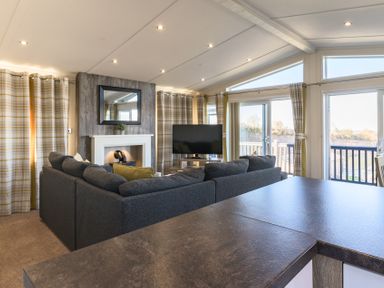 A living room with a television and sofa at Keswick (Pet) Penrith