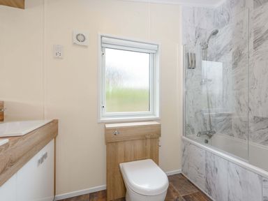 A bathroom with a sink, toilet, and bathtub at Keswick (Pet) in Penrith