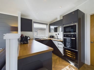 A kitchen with cabinetry and appliances at Spa Sauna Lodge (Pet) Penrith