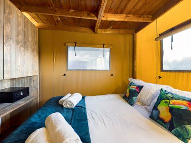 A bedroom with a bed and wooden cabinet at Savannah in Penrith