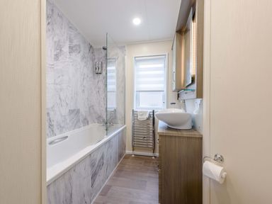 A bathroom with a bathtub and sink at Helvellyn in Penrith