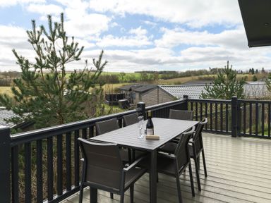 A deck with a table and chairs at Helvellyn (Pet) in Penrith