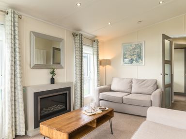 A living room with a sofa and table at Helvellyn (Pet) in Penrith