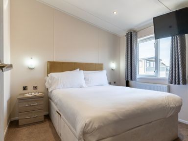 A bedroom with a bed and nightstand at Scaféll in Penrith