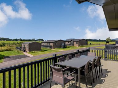 A terrace with a table and chairs at Scaféll (Pet) Penrith