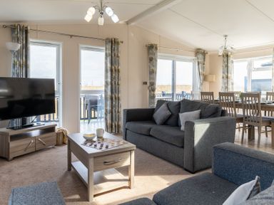 A living room with a sofa and television at Scaféll (Pet) in Penrith