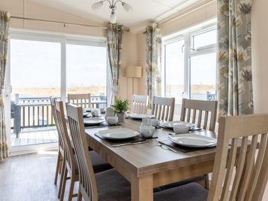 A dining room with a large table set for a meal at Scaféll (Pet) in Penrith