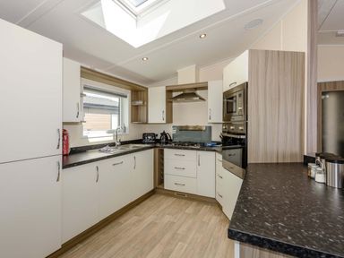 A kitchen with cabinets and appliances at Scaféll (Pet) in Penrith