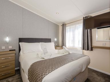A bedroom with a bed and television at Scaféll (Pet) in Penrith