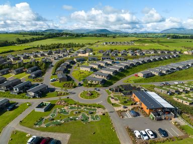 An aerial view of a holiday park with cabins and play areas at Scaféll (Pet) Penrith