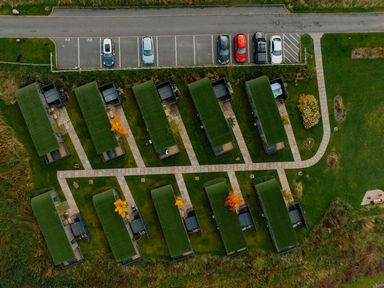 An outdoor area with cabins and a parking lot at Scaféll (Pet) in Penrith