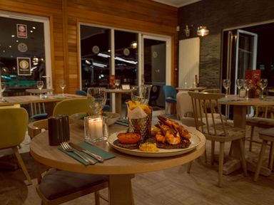 A dining area with a table set and food at Scaféll (Pet) Penrith