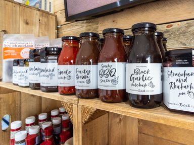 A shelf with various sauces and jam at Scaféll (Pet) Penrith