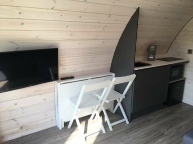 A kitchen with a TV, sink, and folding table at Pod 5 (Pet Friendly) in Carnforth