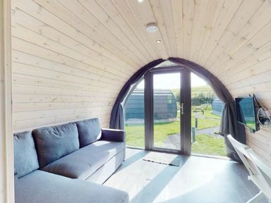 A living area with a sofa and television at Pod 9 (No Pets) in Carnforth