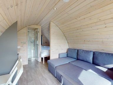 A living area with shower and bed in Pod 9 (No Pets) in Carnforth