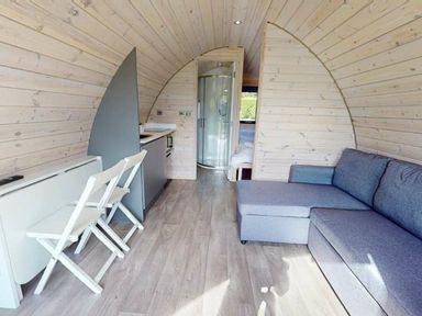 A living area with kitchenette and shower at Pod 9 (No Pets) in Carnforth