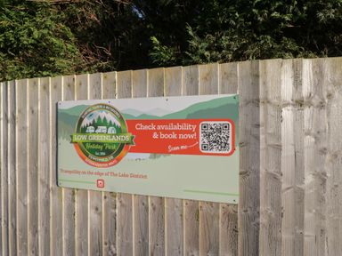 A sign for Low Greenlands Holiday Park near Tewitfield in the Lake District