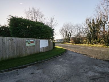 A view of a road with a fence and trees at Pod 9 (No Pets) Tewitfield near Carnforth