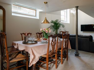 A dining room with a table and chairs at The School House in Newton Abbot