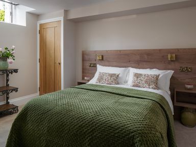 A bedroom with a bed and bedside table at The School House in Newton Abbot